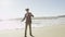 Young man walks on the Pacific beach