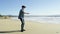 Young man walks on the Pacific beach