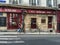 Young man walks past Paris restaurant