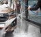 Young man washing car on carwash station outdoor