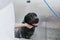 Young man washing and cleaning a black labrador in grooming salon. animals clean and healthy concept