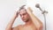 Young man washing hair under shower.Man washes his hair at home.