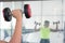 A young man watches arm muscle standing in front of the mirror