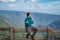 Young man watching the mountain range with bright blue sky at afternoon from flat angle