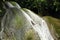 Young man in waterfall