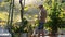 Young man watering plants in garden