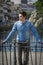 Young man wearing denim shirt on city bridge in Treviso, Italy