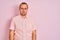 Young man wearing elegant shirt standing over isolated pink background depressed and worry for distress, crying angry and afraid