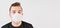 Young man wearing home made cotton face mouth nose virus mask. Studio portrait with space for text right side - can be used during