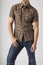 Young man wearing plaid western wear shirt and denim jeans. Men`s trendy casual clothing fashions styles.