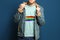 Young man wearing t-shirt with image of LGBT pride flag on blue background