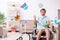 Young man in wheel-chair cleaning the house