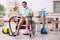 Young man in wheel-chair cleaning the house