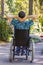 Young man in a wheelchair enjoying fresh air on a sunny day