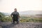 Young man in wheelchair enjoying fresh air in sunny day on the mountains. People with disabilities travelling.