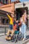 Young man in a wheelchair tossing a hat with two young girls