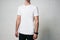 Young man in white blank t-shirt, horizontal studio portrait, em