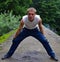 Young man in a white T-shirt and blue trousers with surprise looks