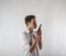 Young man in white using smartphone. Man taking selfie over bright background