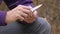 Young man whittling twig