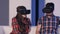 Young man and woman adjusting virtual reality glasses to watch movie