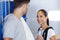 Young man and woman chatting in sports locker room