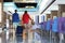 Young man, woman and child with suitcase go to hotel lobby