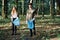 Young man and woman cleaning up a forest. Volunteers picking plastic waste to bags