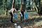 Young man and woman cleaning up a forest. Volunteers picking plastic waste to bags