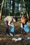 Young man and woman cleaning up a forest. Volunteers picking plastic waste to bags