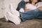 Young man and woman, couple in love lying on bed embracing legs in jeans, casual style, happy together