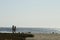 Young man and woman couple silhouettes walking Pacific beach Baja, Mexico