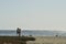 Young man and woman couple silhouettes walking Pacific beach Baja, Mexico