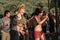 Young man and woman dance at sunset on the Lost Theory psytransce music festival held in Riomalo de Abajo