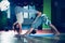 Young man and woman doing acro yoga indoor