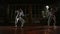 Young man and woman dressed in costumes for fencing lessons in the gym. Wear a suit and begin the battle. In the