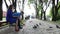 Young man and woman feed pigeons in park