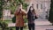 Young man and woman in front of the camera in the middle of the empty street take the mask and wearing on their face