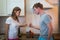 Young man and woman are having a quarrel in kitchen at home, couple household contention and family difficulties.