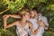 Young man and woman lies together in the field