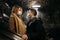 Young man and woman looking at each other in medical masks on escalator in subway.