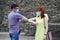 Young man and woman met outdoors and greeting elbows