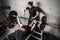 Young man and woman powerlifting in a gritty basement gym