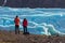 Young man and woman standing before of beautiful evening scenery of Skaftafell glacier Vatnajokull National Park in Iceland