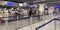 Young man and woman standing in front of 2 different check-in counters in airport.Concept of efficient operations