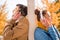 Young man and woman standing in headphones