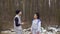 Young man and woman talks in winter forest