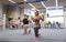 Young man and woman training with barbell in gym