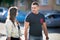 Young man and woman walking on the street