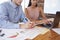 Young man and woman working together at an office desk, crop